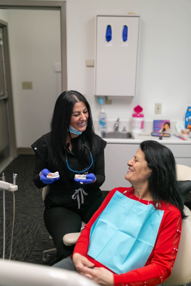 Dentist and patient discussing dentures
